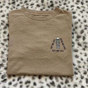 A cream T-shirt from last call company size small